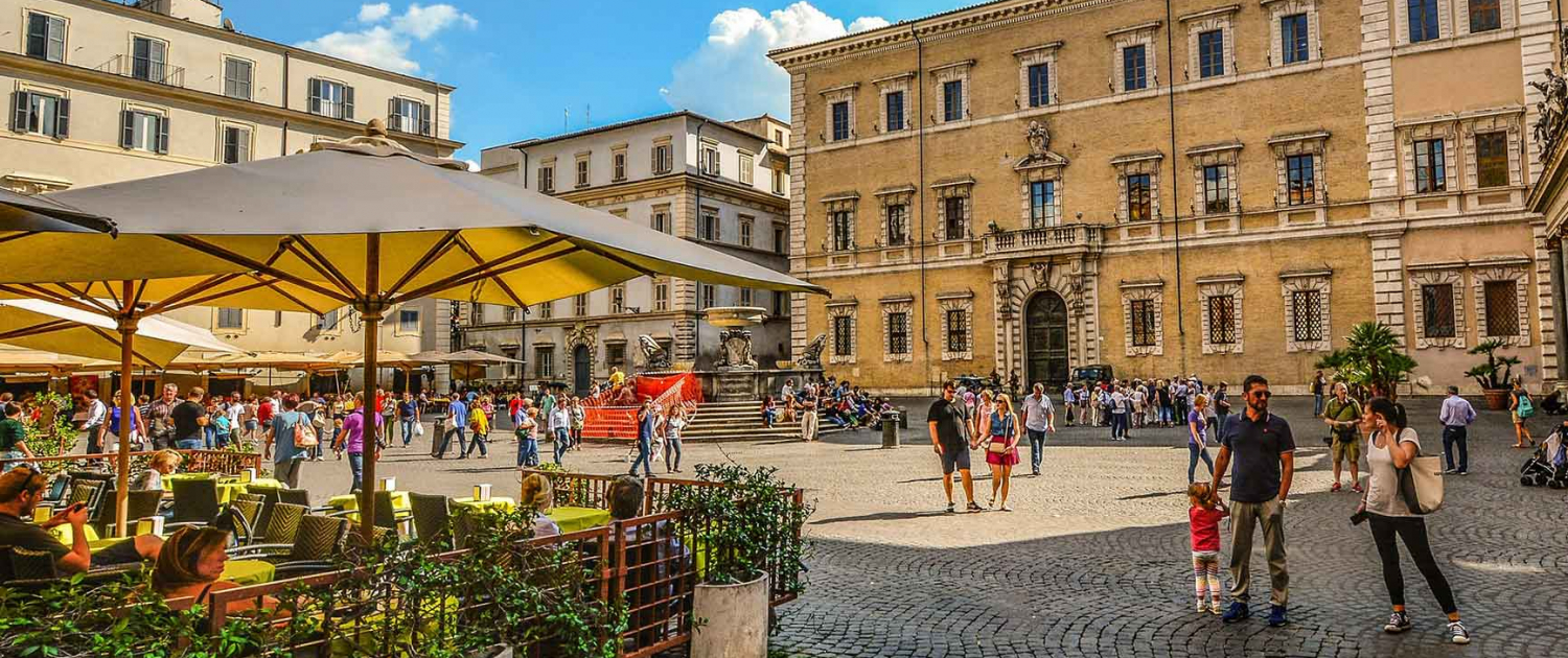 Trastevere square in Itly depicting familes spendng time together